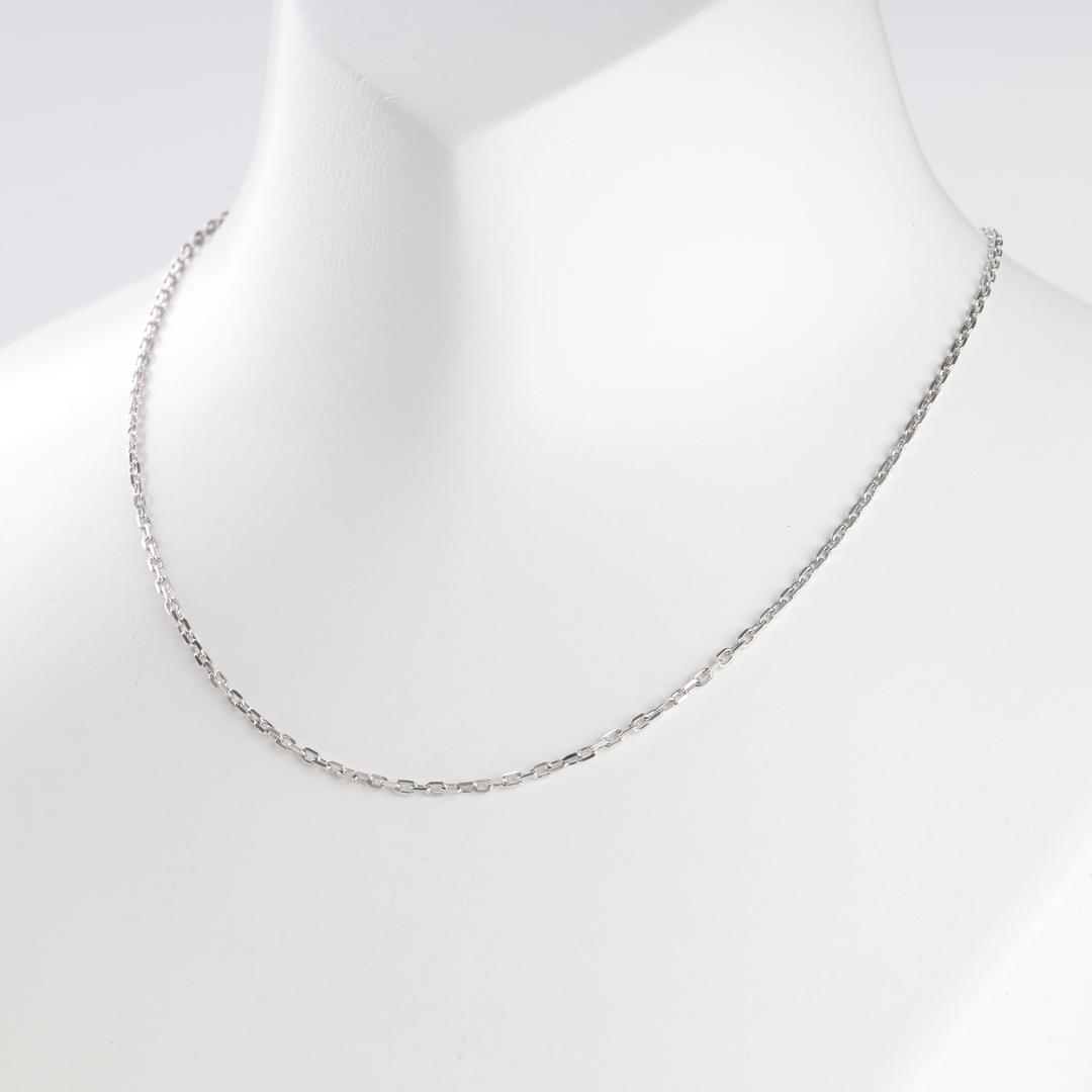 Silver chain necklace with small rectangular links displayed on a white mannequin for jewelry, minimalist chain necklace.