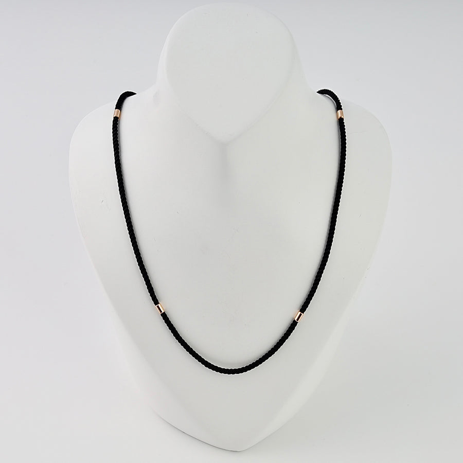 Black cord necklace with small gold tube beads on bust display, minimalist Ukrainian Jewelry, simple gold chain necklace for women.