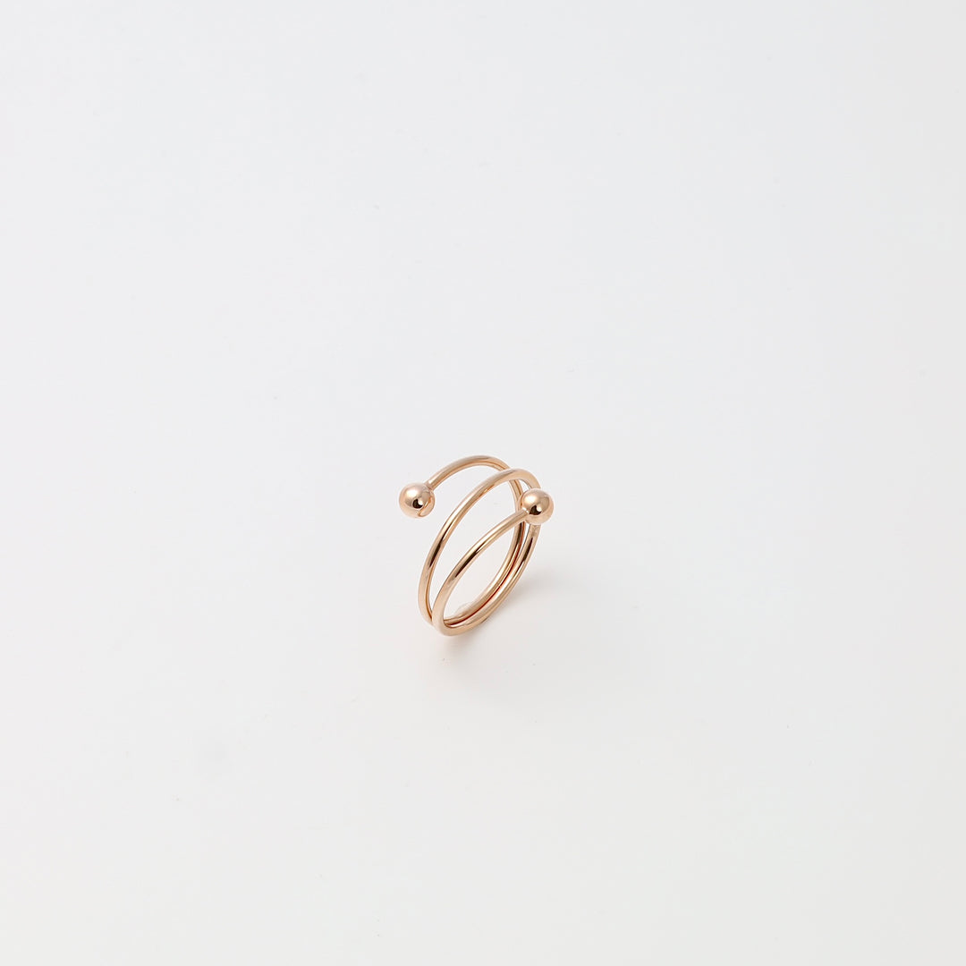 Minimalist 14k gold open spiral ring with two ball ends on white background, modern Ukrainian Jewelry, dainty gold ring gift.