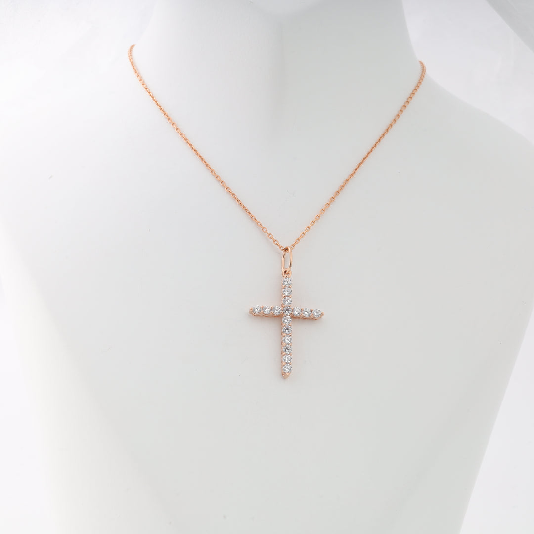 Rose gold chain necklace with a cubic zirconia cross pendant displayed on a white bust. Cross pendant necklace, dainty jewelry.