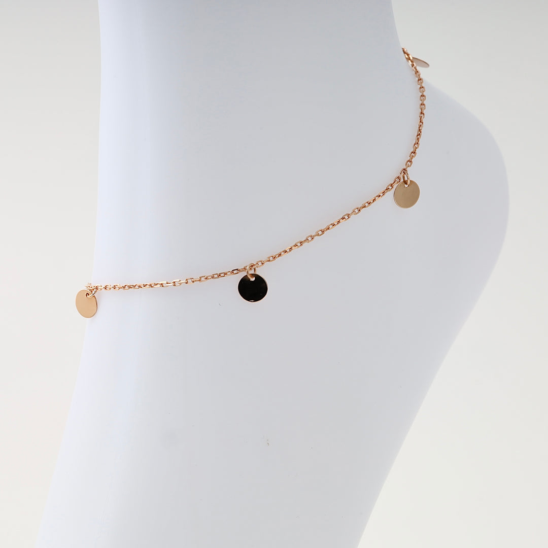 14k gold anklet with small round disc charms displayed on ankle, minimalist chain Ukrainian Jewelry, dainty gold ankle bracelet.