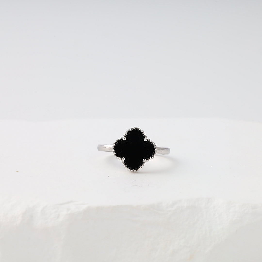 Sterling silver ring with black clover-shaped stone on white display, Ukrainian Jewelry, minimalist silver ring, black stone ring.