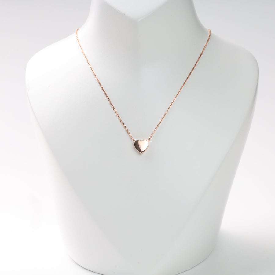 Rose gold heart pendant necklace on a white display bust, rose gold heart necklace, rose gold pendant.