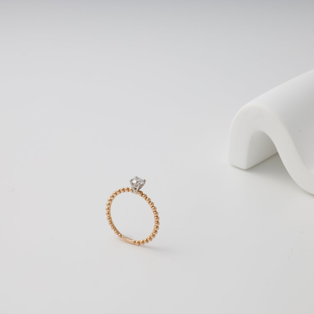 Delicate 14k gold beaded ring with single clear stone solitaire on white background, Ukrainian Jewelry, minimalist gold engagement ring.