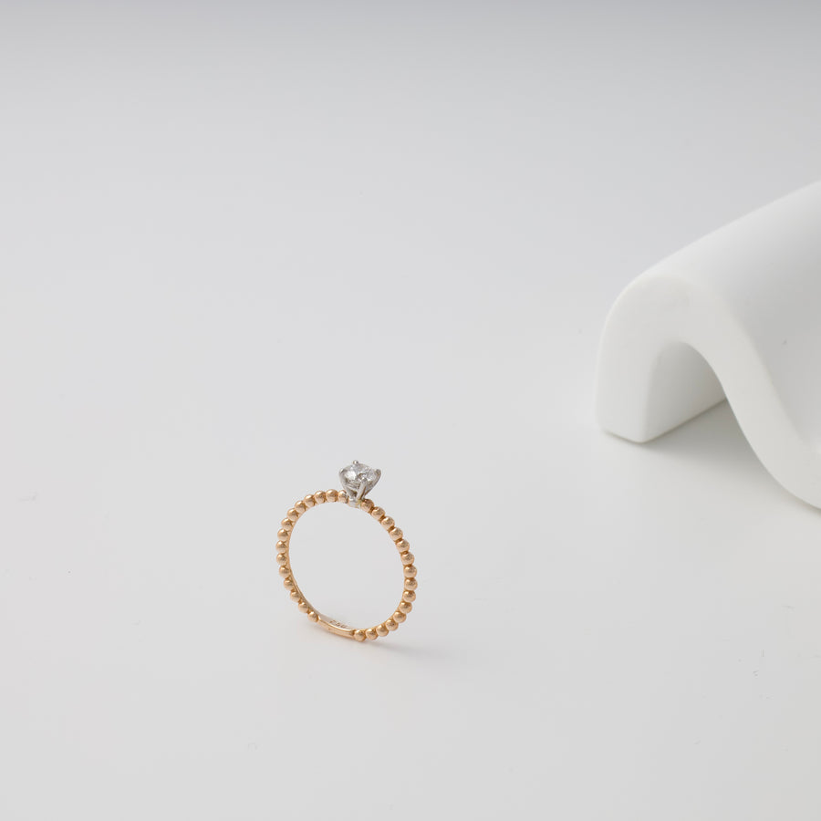 Delicate 14k gold beaded ring with single clear stone solitaire on white background, Ukrainian Jewelry, minimalist gold engagement ring.
