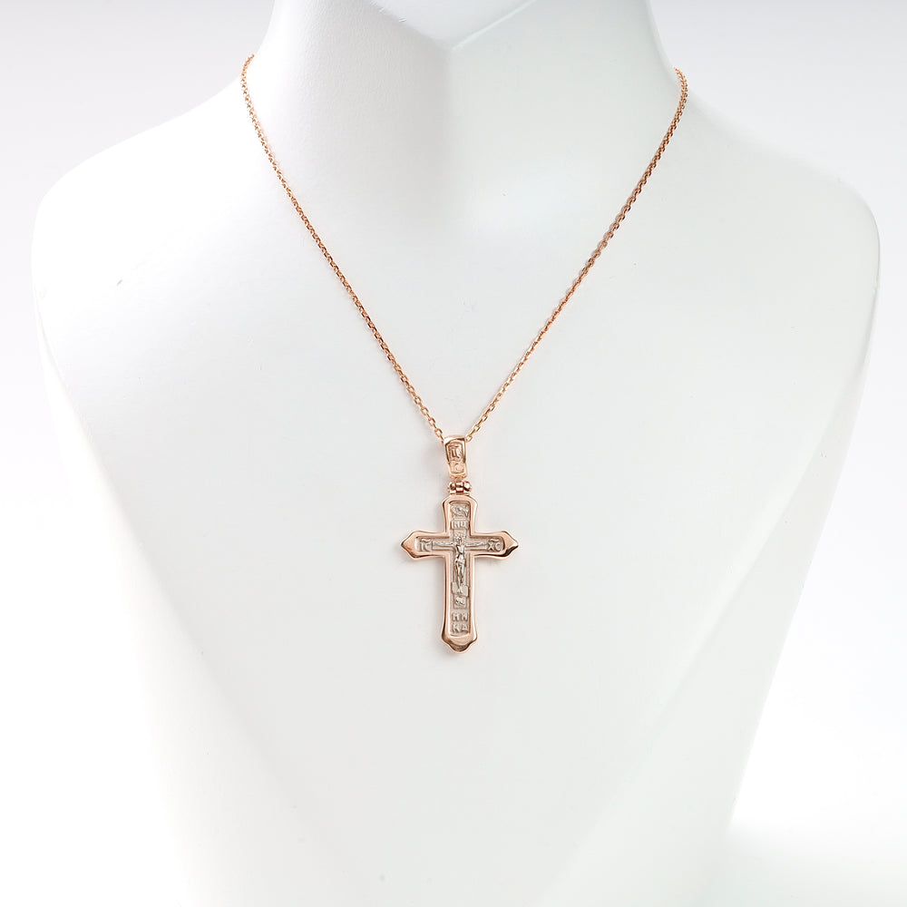 Gold chain necklace with a crucifix cross pendant displayed on a white bust, religious jewelry, unisex accessory.