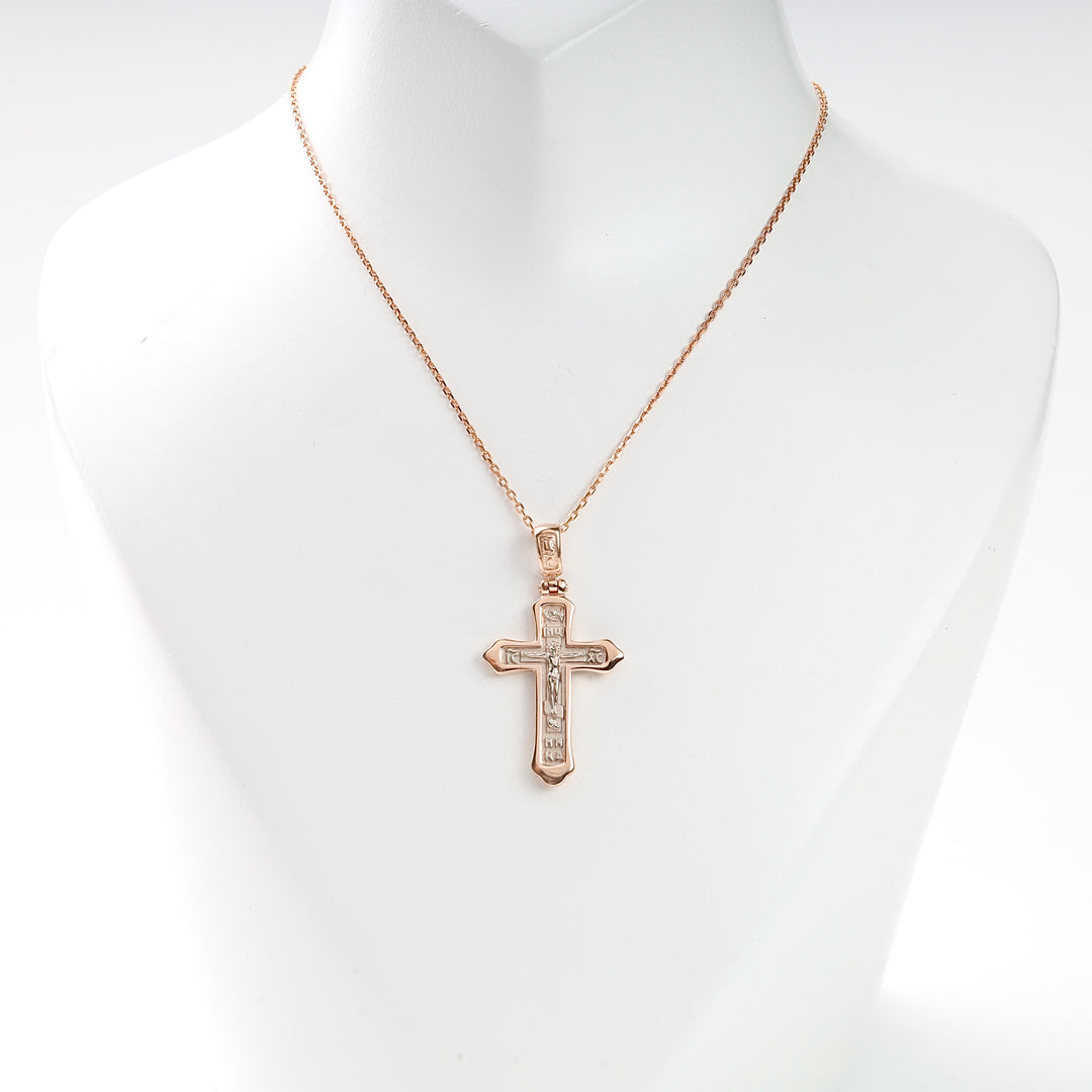 Gold chain necklace with a crucifix cross pendant displayed on a white bust, religious jewelry, unisex accessory.