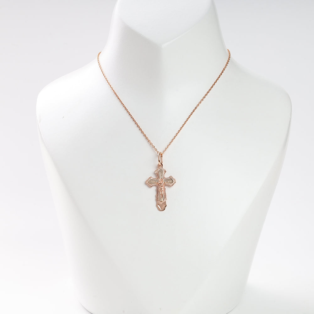 Rose gold cross pendant necklace with intricate details displayed on a white bust for jewelry, religious, and gift keywords.