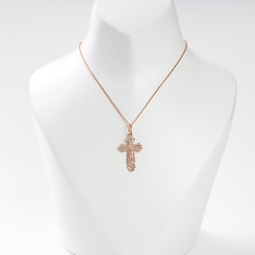 Rose gold cross pendant necklace with intricate details displayed on a white bust for jewelry, religious, and gift keywords.