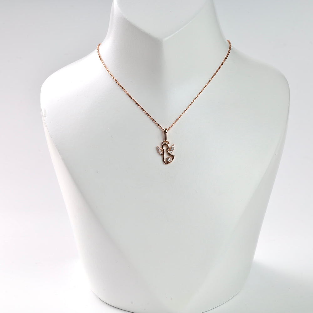 Rose gold swan pendant necklace with clear crystals on display.