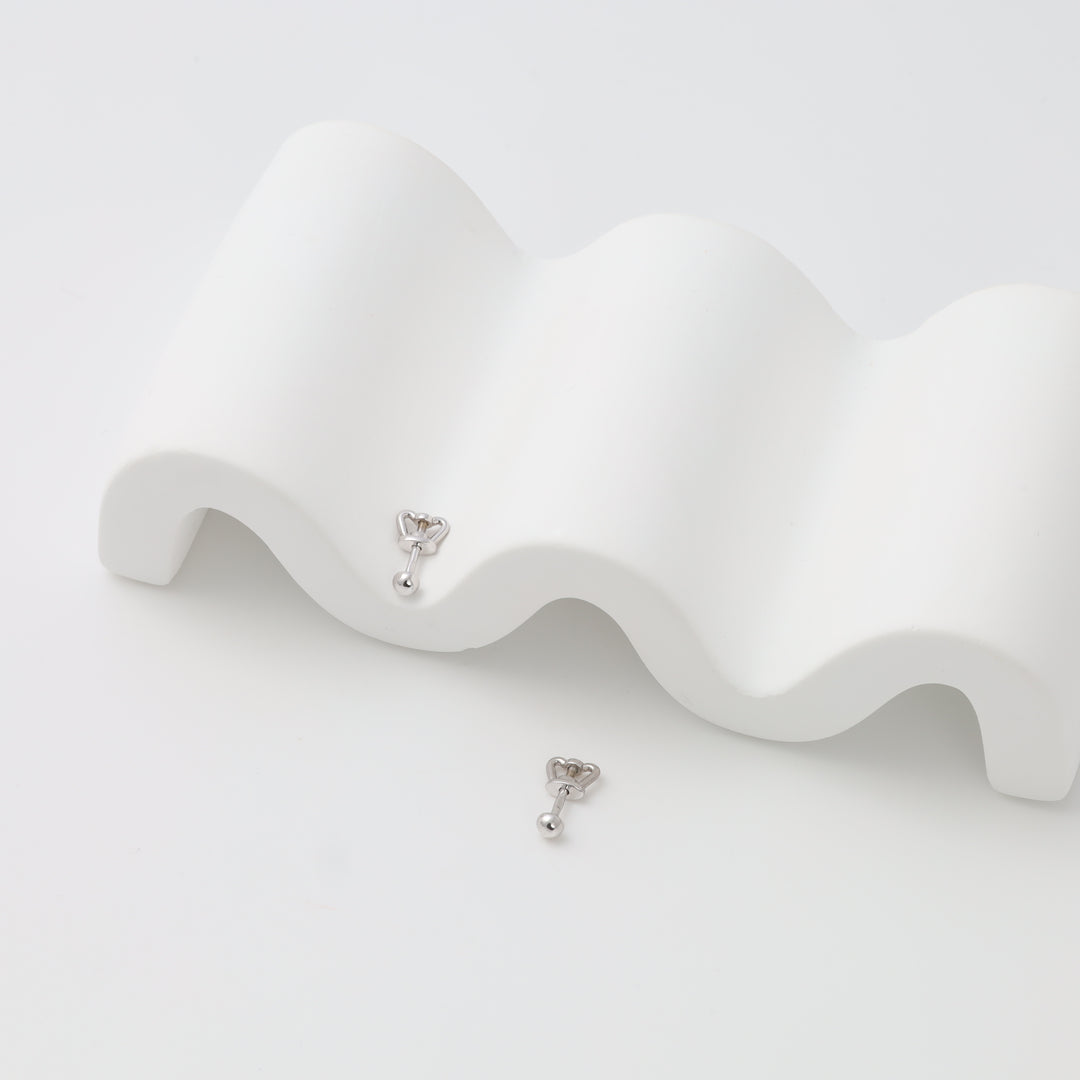 Sterling silver crown cartilage barbell earrings on white display, minimalist Ukrainian Jewelry, silver stud earrings for helix piercing.