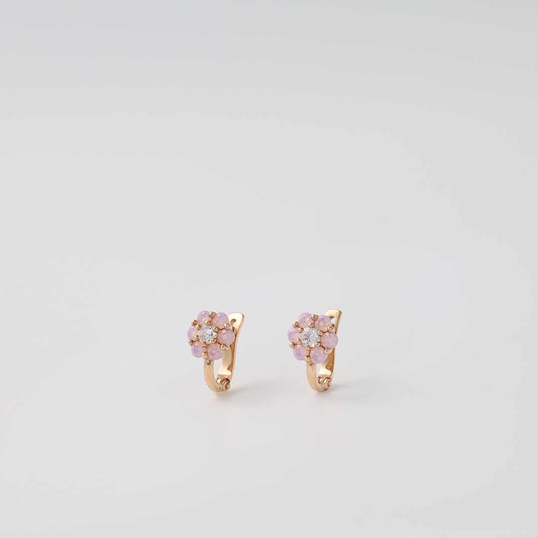 Pair of 14k gold flower earrings with pink stones and clear crystals on white background, Ukrainian Jewelry, gold floral stud hoops.