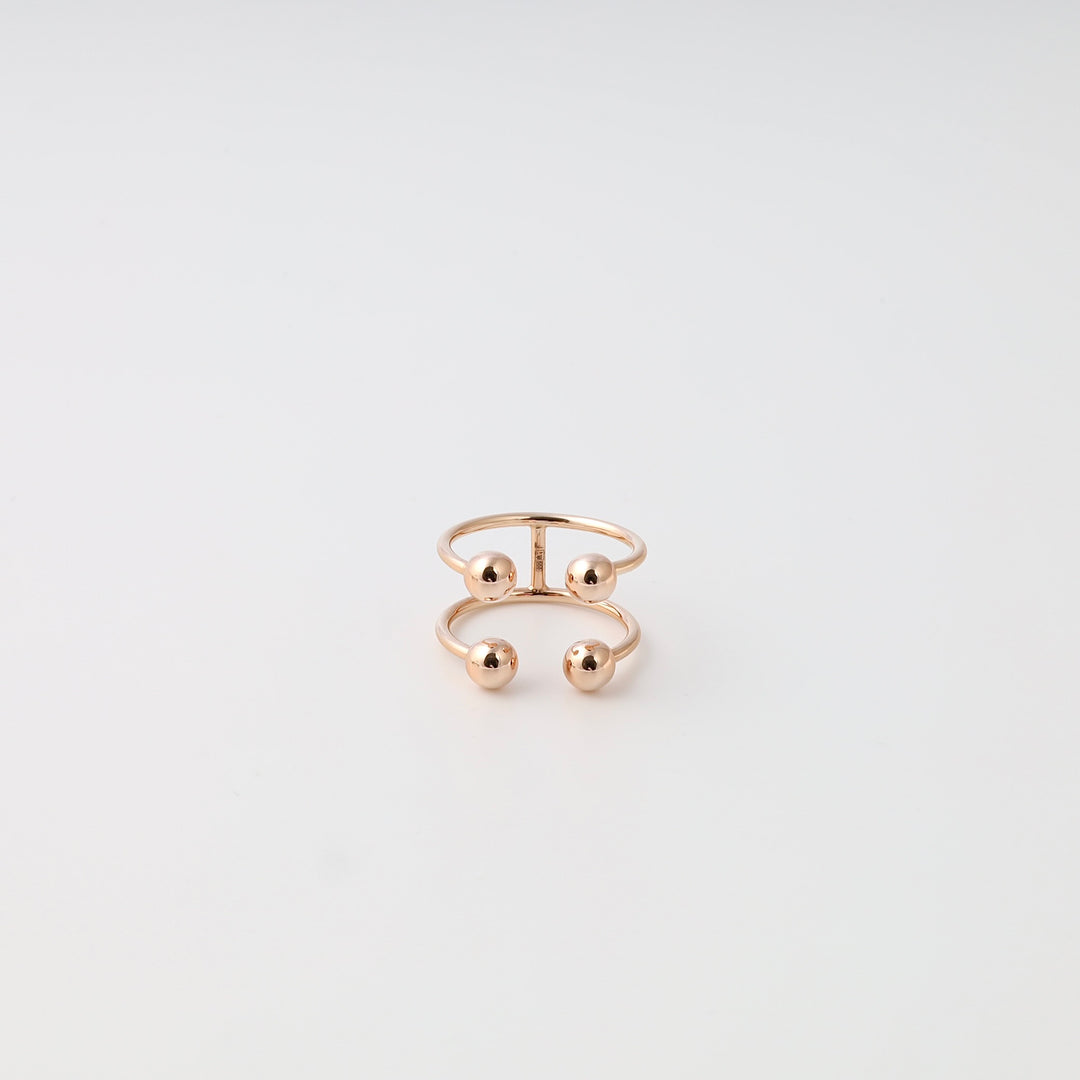 14k gold open band ring with four ball accents on white background, minimalist Ukrainian Jewelry, modern gold statement ring.