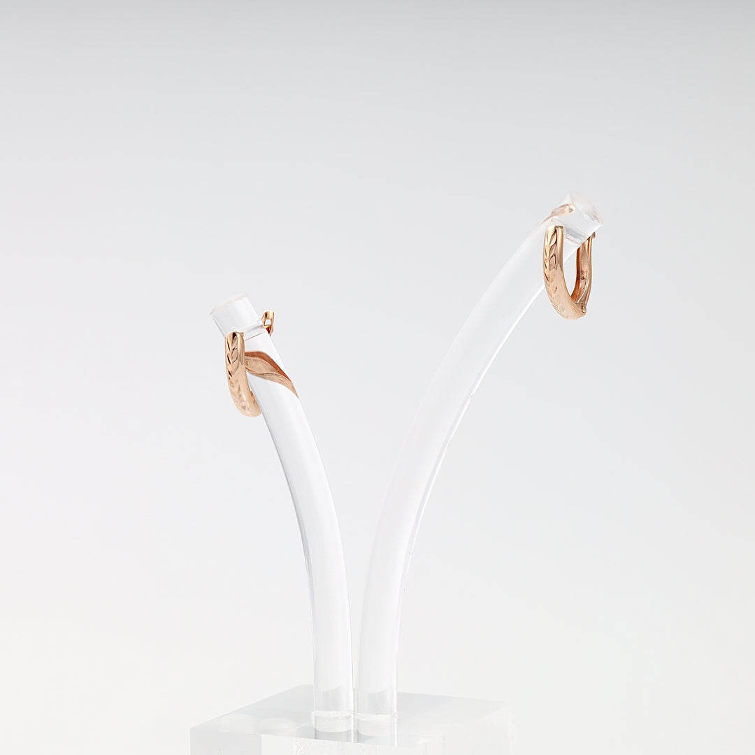 Pair of small 14k gold hoop earrings with engraved pattern on display stand, Ukrainian Jewelry for everyday gold hoop earrings.