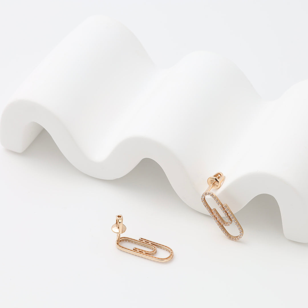 14k gold paperclip stud earrings with pavé crystals on white display, minimalist Ukrainian Jewelry, modern gold earrings gift.