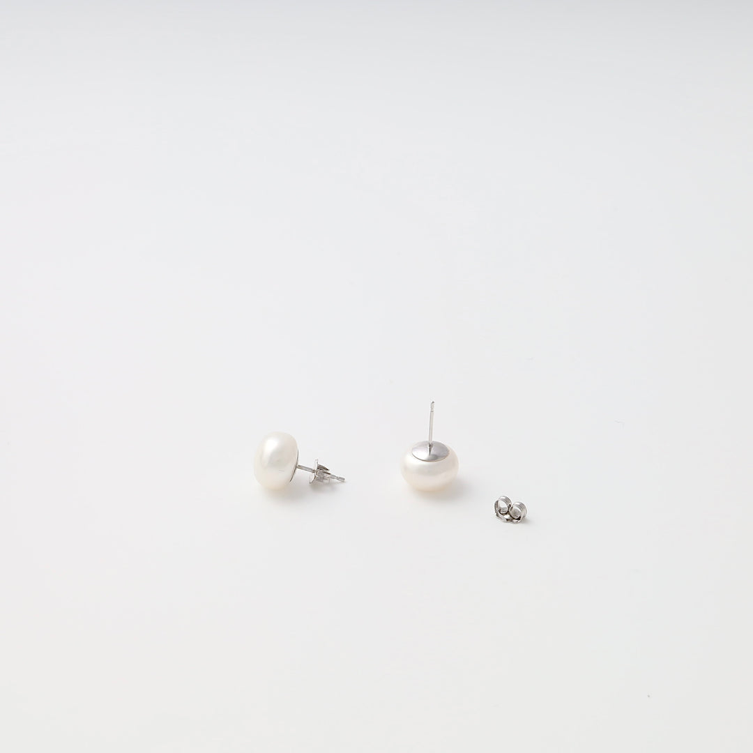 Sterling silver pearl stud earrings on white background, classic Ukrainian Jewelry, simple silver stud earrings for women.