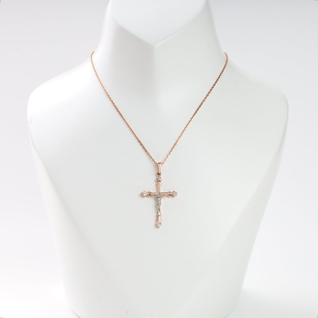 Gold crucifix necklace with a detailed Jesus motif displayed on a white bust, religious jewelry, Christian cross pendant.