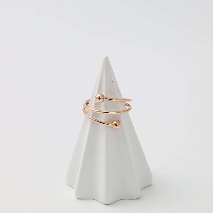 Gold open wrap ring with two ball ends displayed on a cone stand, minimalist Ukrainian Jewelry, simple gold stacking ring.