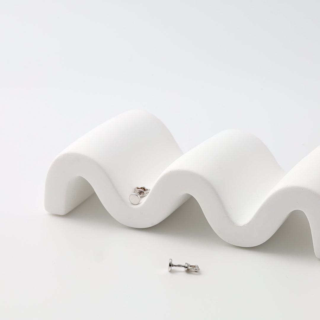 Sterling silver circle stud earrings on white display, minimalist Ukrainian Jewelry for everyday silver stud earring lovers.