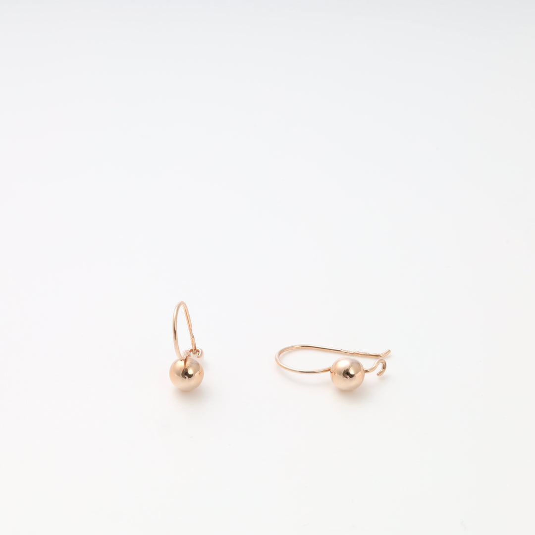 Rose gold earrings with small gold ball drops, minimalist dangle earrings by Ukrainian Jewelry for everyday gold drop earring style.