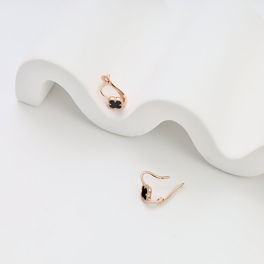 14k gold drop earrings with black stone and halo detail, displayed on white backdrop, Ukrainian Jewelry, dainty gold dangle earrings.