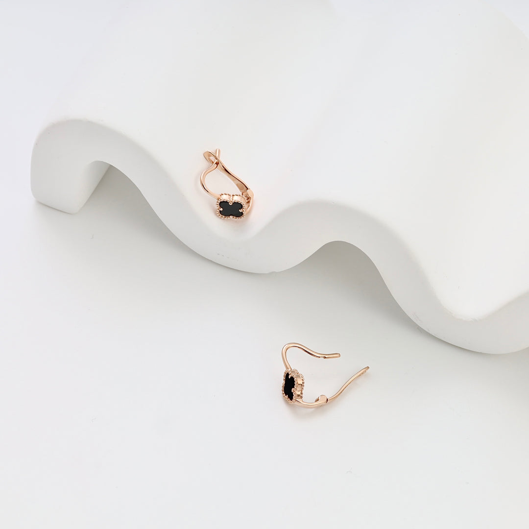 14k gold drop earrings with black stone and halo detail, displayed on white backdrop, Ukrainian Jewelry, dainty gold dangle earrings.